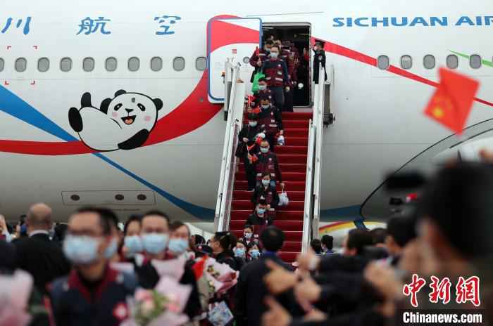 机舱打开,医护人员走下飞机。 王磊 摄 最后一批援湖北“白衣川军”归家:“一个都没有少”